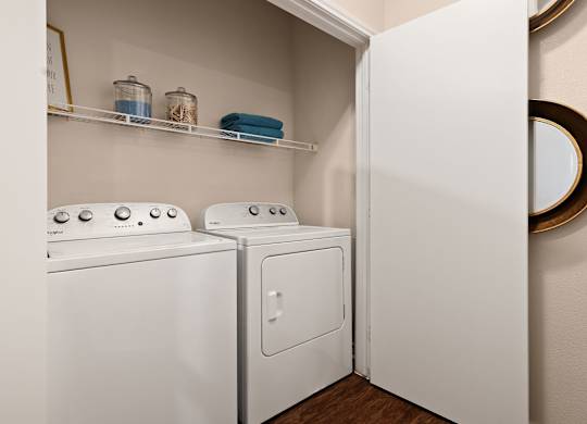 A white washing machine and dryer in a small laundry room.