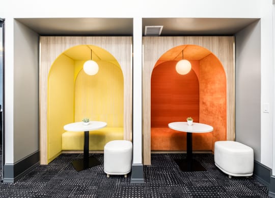 a meeting room with two tables and a yellow and orange wall