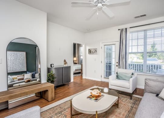 a living room with white walls and hardwood floors