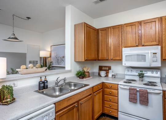 a kitchen with white appliances and wooden cabinets