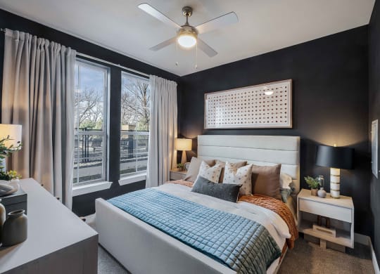 a bedroom with a large bed and a ceiling fan