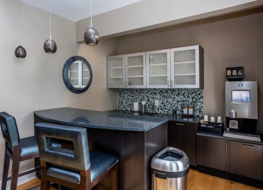 a kitchen with a counter top and two chairs