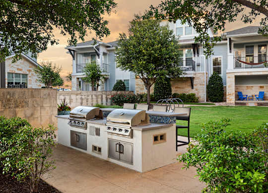 Outdoor kitchen with a grill and sink.