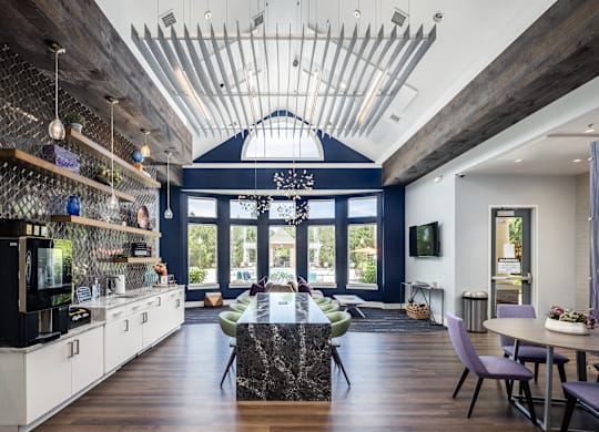 A modern kitchen with a black countertop and a large island in the center.