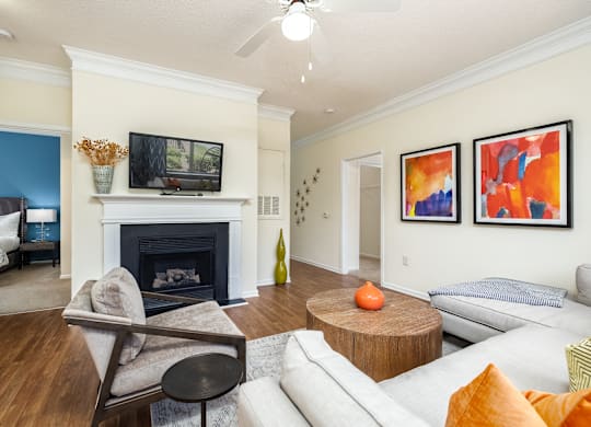 A living room with a fireplace and a television on the wall.