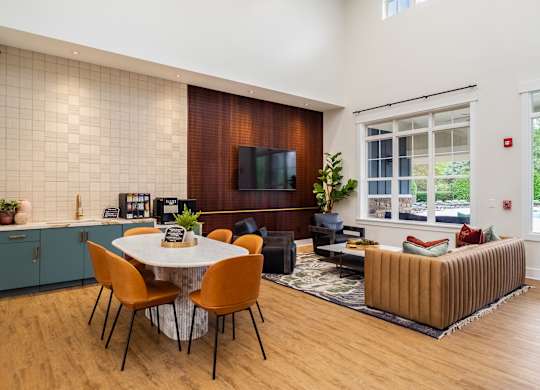 a living room and dining room with a table and chairs