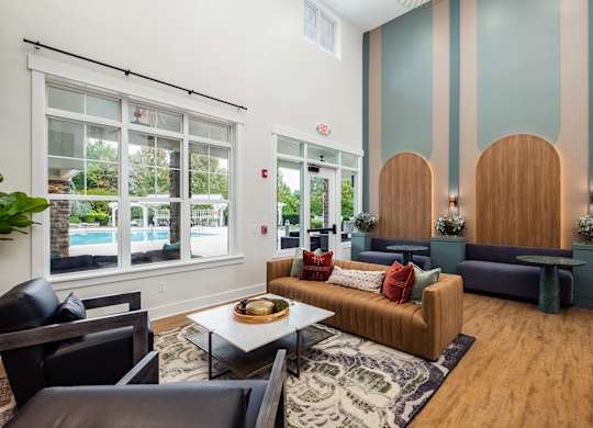 a living room with couches and chairs and a table