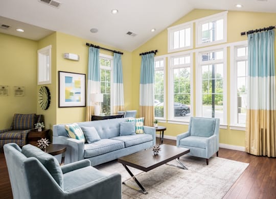 A living room with a blue couch and a coffee table.