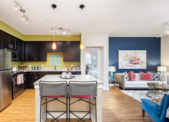 A modern kitchen with a dining table and chairs.