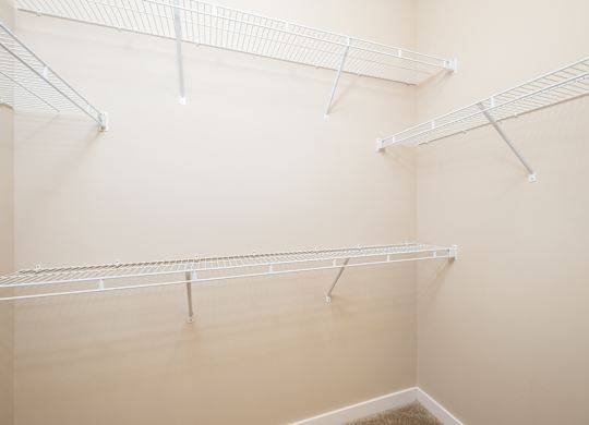 Empty white shelves in a room.