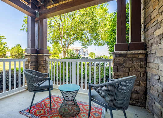 A patio with a chair and a table.