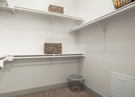 A small room with a wire basket on the floor.