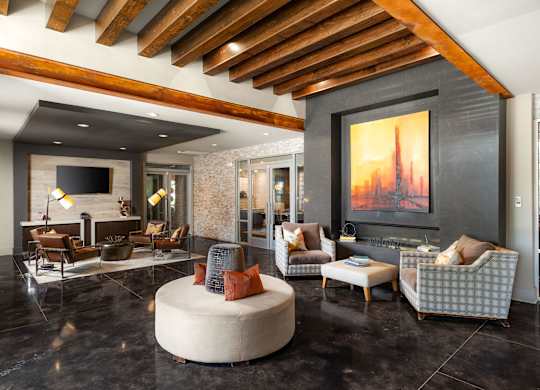 A modern living room with a wooden ceiling and a large painting on the wall.