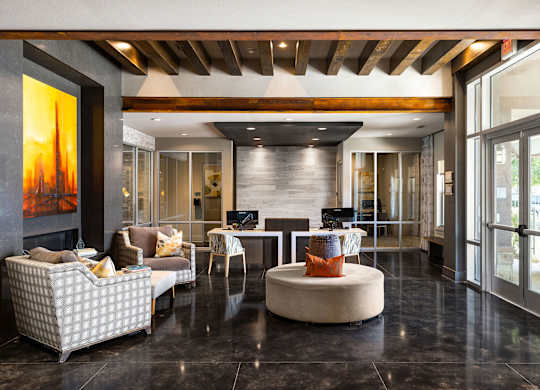 A modern living room with a fireplace and a painting on the wall.