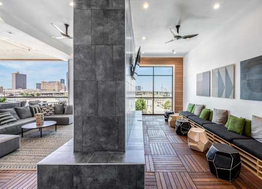A modern living room with a large window overlooking the city.