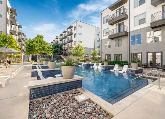 a swimming pool in between two apartment buildings