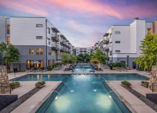 an apartment building with a swimming pool and buildings