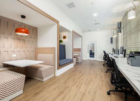 A modern office space with a wooden floor and a white table.