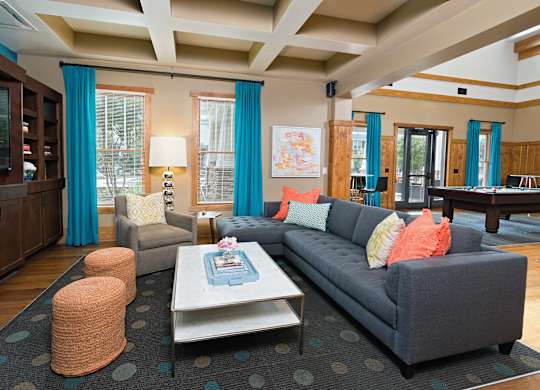 A living room with a grey couch and a coffee table.