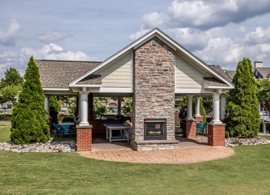 a home with a stone fireplace in the front yard