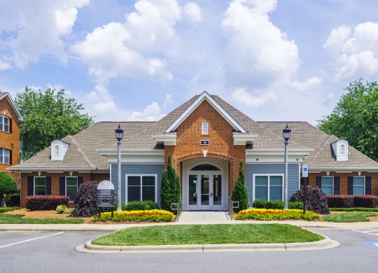 a house with a driveway and lawn in front of it