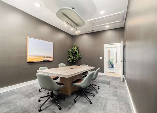 A conference room with a long table and chairs.