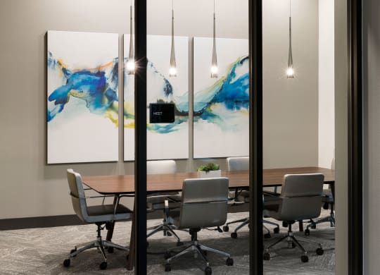 a conference room with a wooden table and chairs