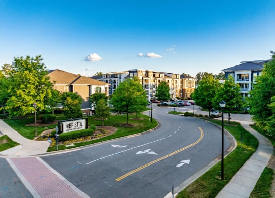 an empty street with an apartment building in the background