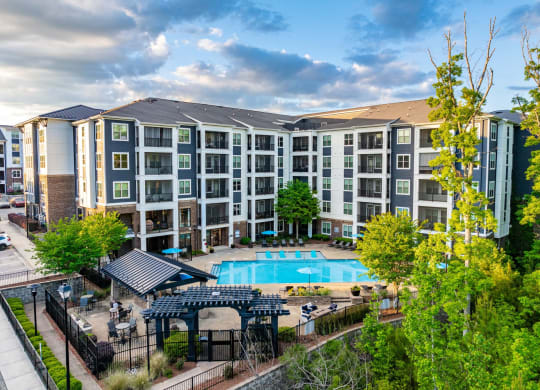 an aerial view of an apartment building with a swimming pool