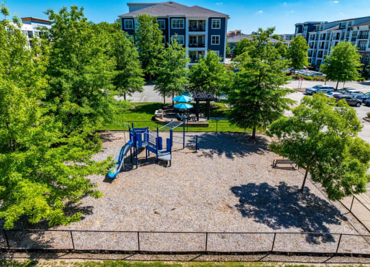 an aerial view of a playground in a park with trees