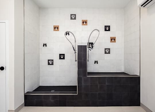 A modern bathroom with a walk-in shower and a black bench seat.