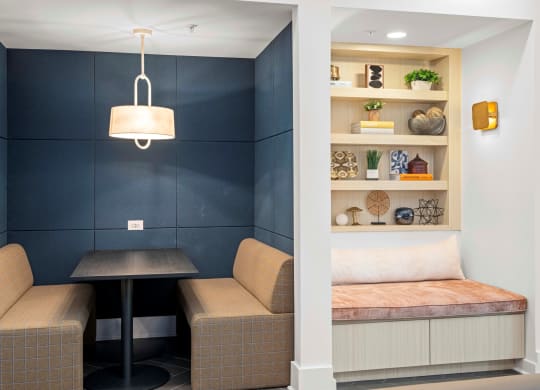 a small living room with a table and two couches