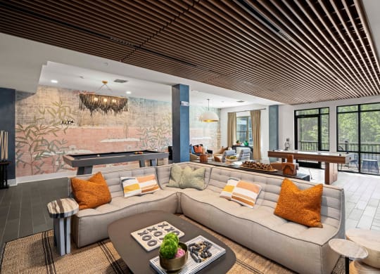 a living room with a couch and a pool table
