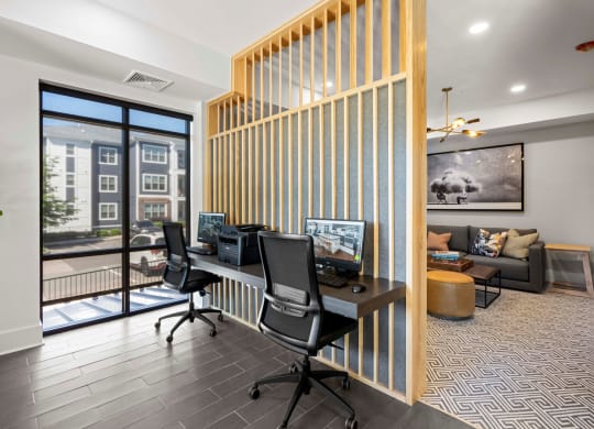 a home office with two desks and a window