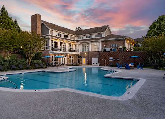 A large house with a pool in front.