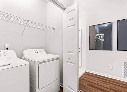 A white washer and dryer in a laundry room.