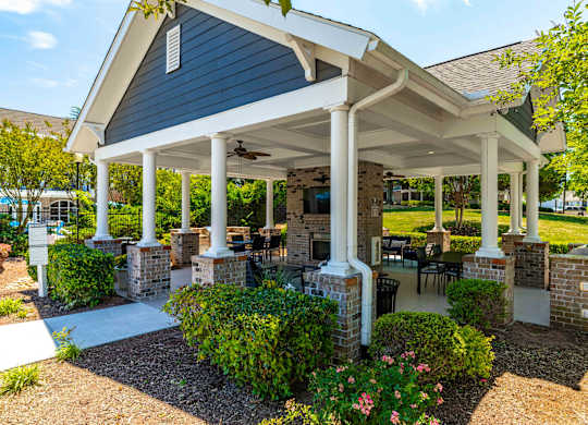 A covered patio area with a table and chairs.