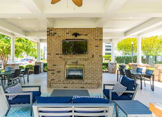 A patio with a fireplace and seating area.
