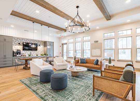 a living room filled with furniture and a large chandelier