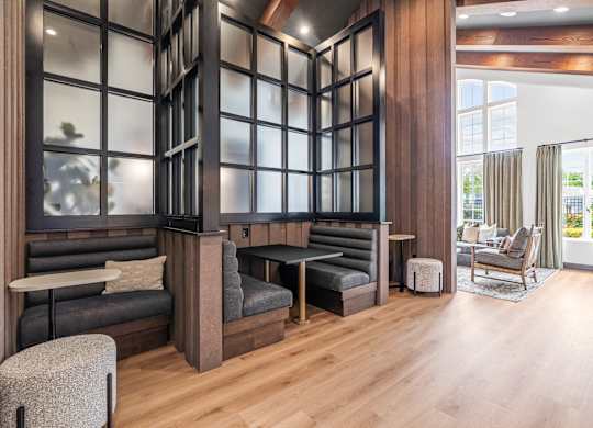 A modern living room with a grey sofa and a wooden floor.