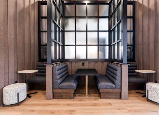 A modern lounge area with grey and black furniture.