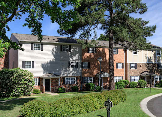 Apartment complex with a mix of brick and siding exteriors.