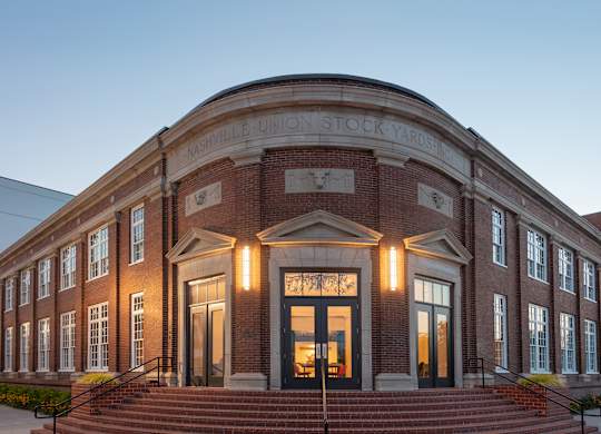 the front of the union stock yard building at night