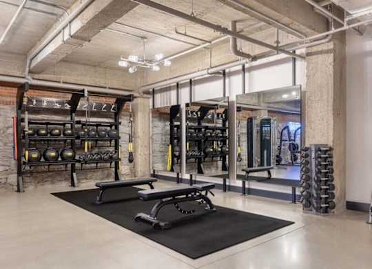 a gym with weights and equipment in a loft