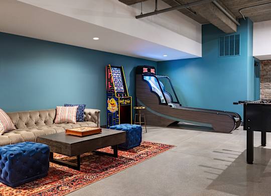 a game room with a piano and a couch and a coffee table