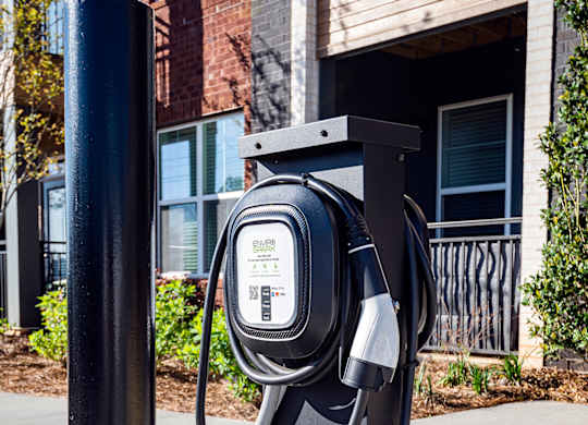 a pay phone on a sidewalk in front of a building