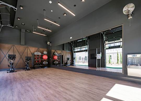 a large room with hardwood floors and large windows