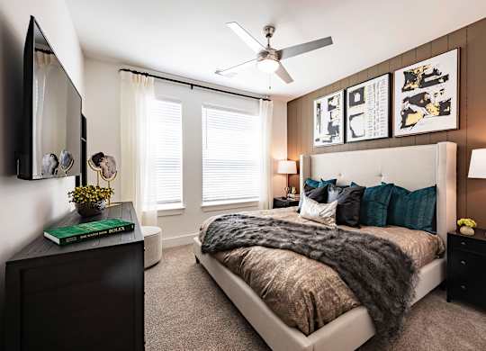 a bedroom with a large bed and a ceiling fan
