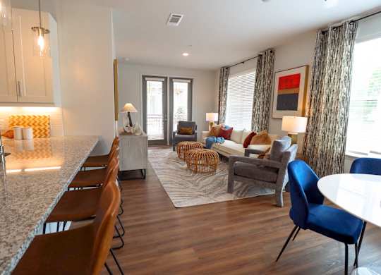 a living room with a kitchen and a dining room