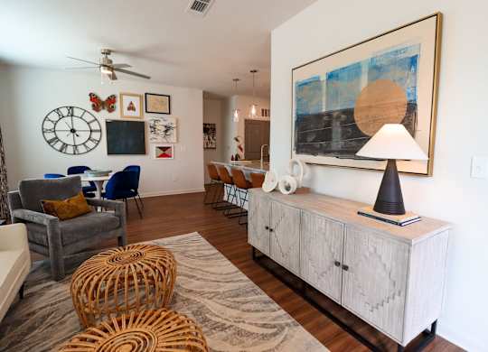 the living room of a house with a large painting on the wall